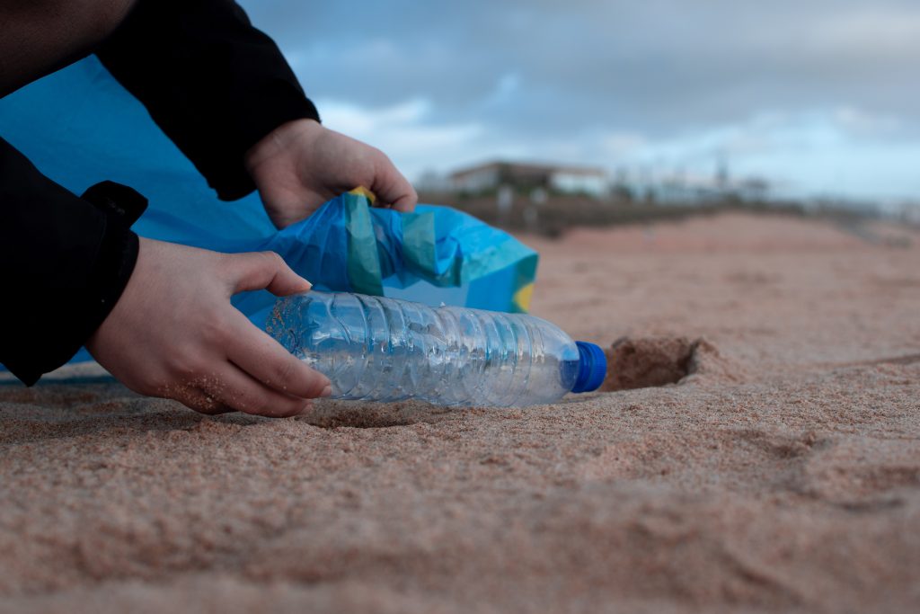 water bottle on the beach which questions its sustainability