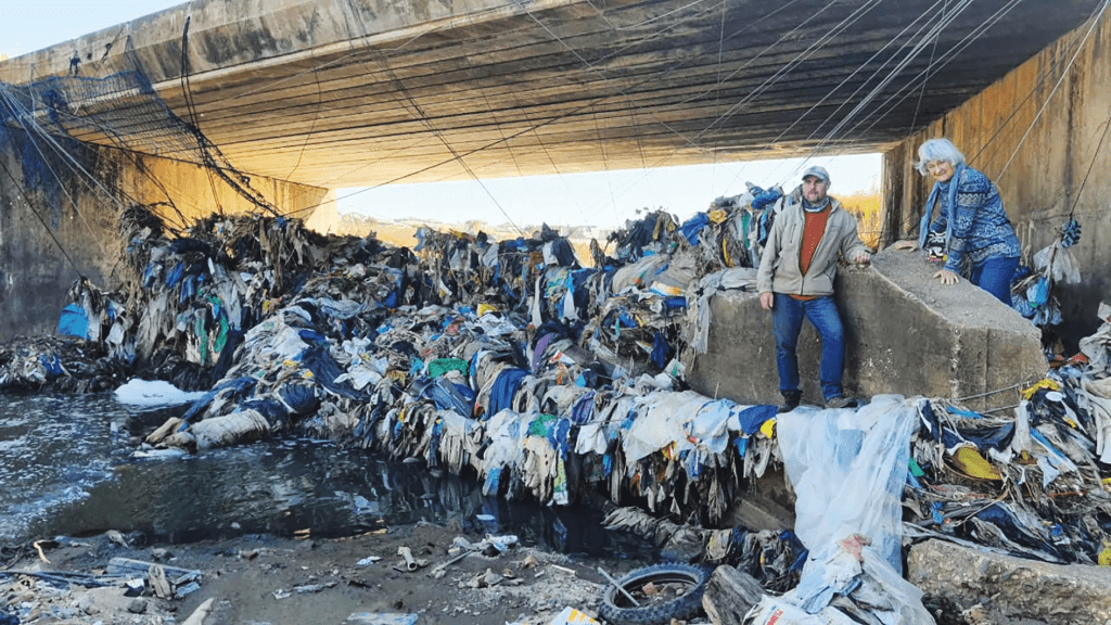 cost of corruption - This image shows large amounts of junk and waste that have been captures by a river-trap in South Africa. The river-trap was built by the NGO "Armour" to stop waste flowing into the Hennops River. Waste dumping into streams is another environmental cost of corruption.