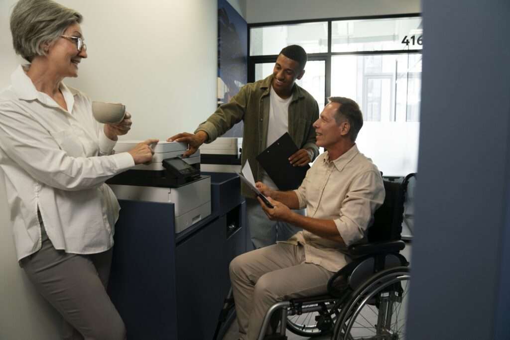 people using a printer, including a wheelchair user