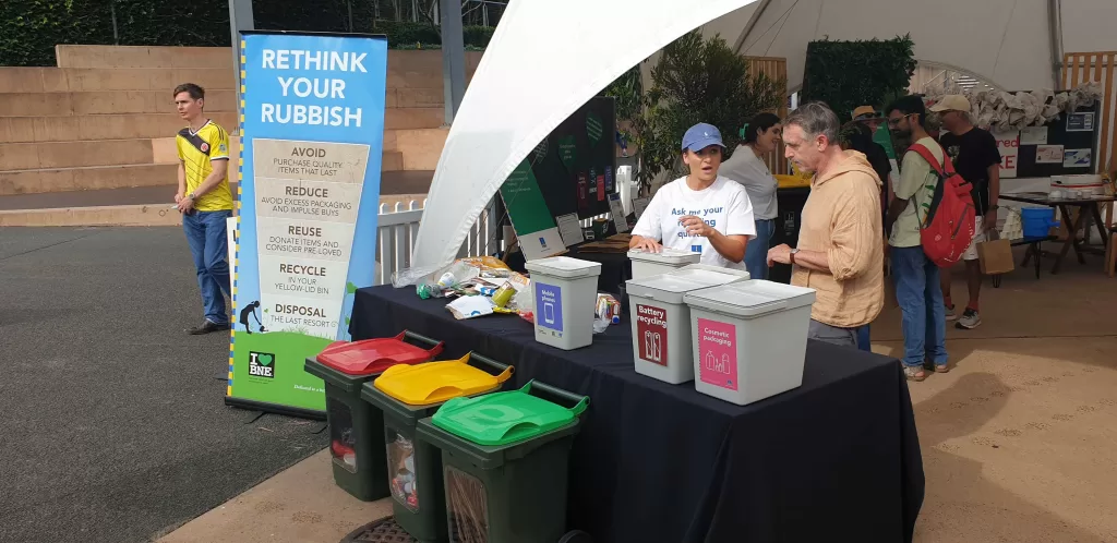 People showing recycling bins People showing recycling bins