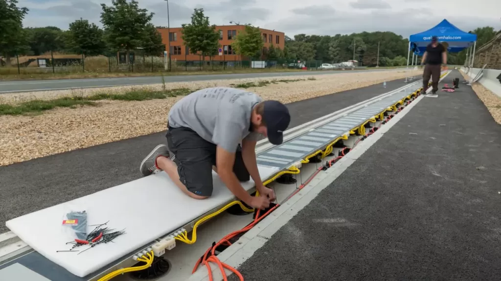 General image representation of an inductive EV charging road installation below Asphalt